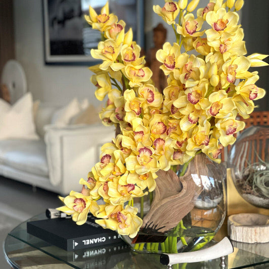 Yellow Cymbidium Orchids in Moon Vase